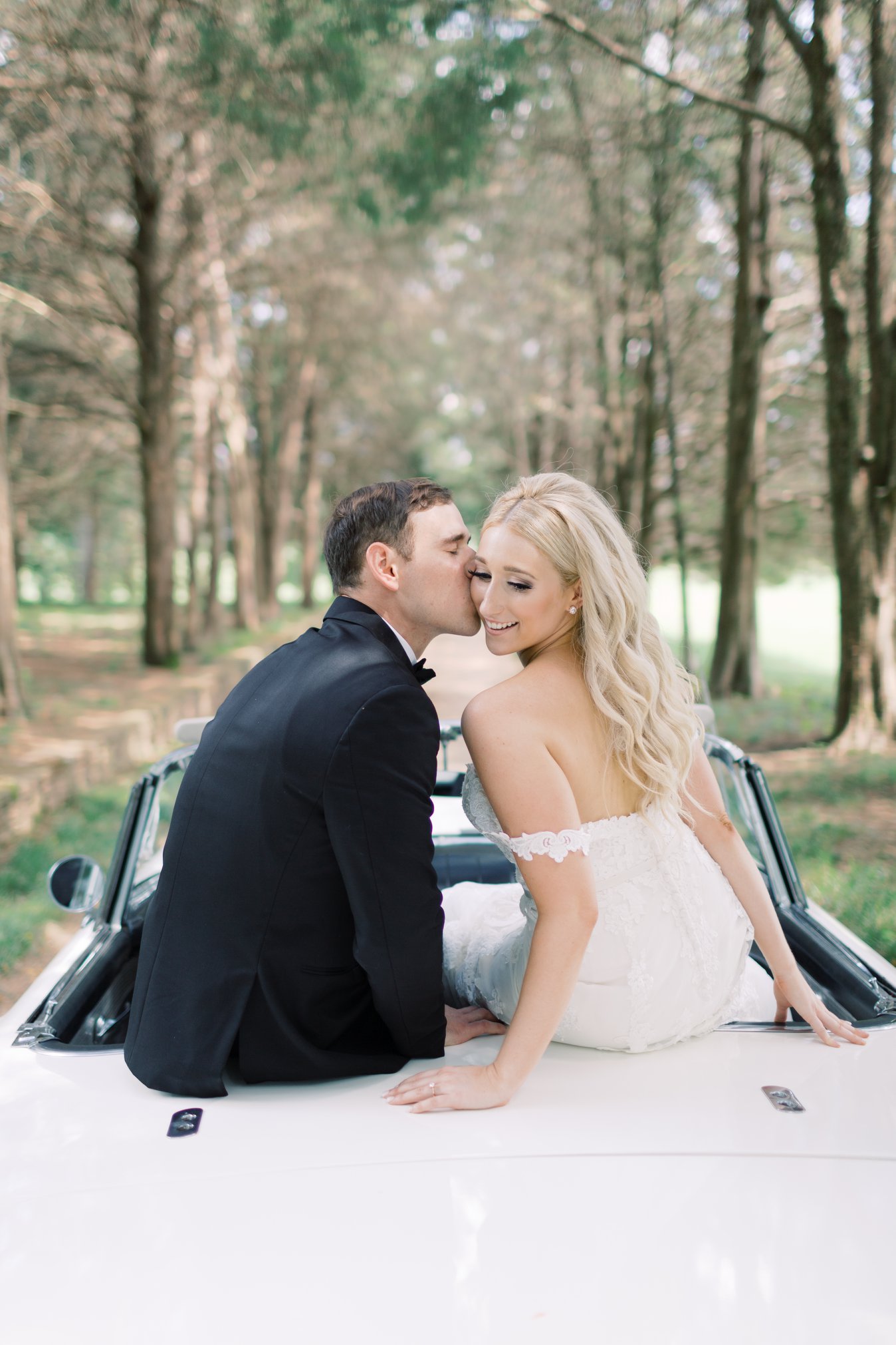 Estate Wedding, bride and groom sitting in the back of car